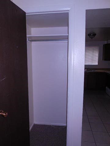 a white refrigerator in a kitchen with a door
