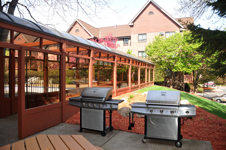 Two silver grills next to shaded terrace