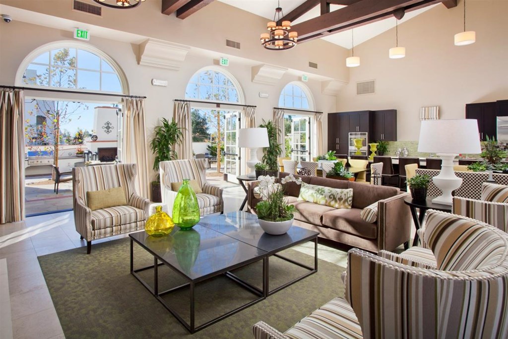 a living room with couches and chairs and a table