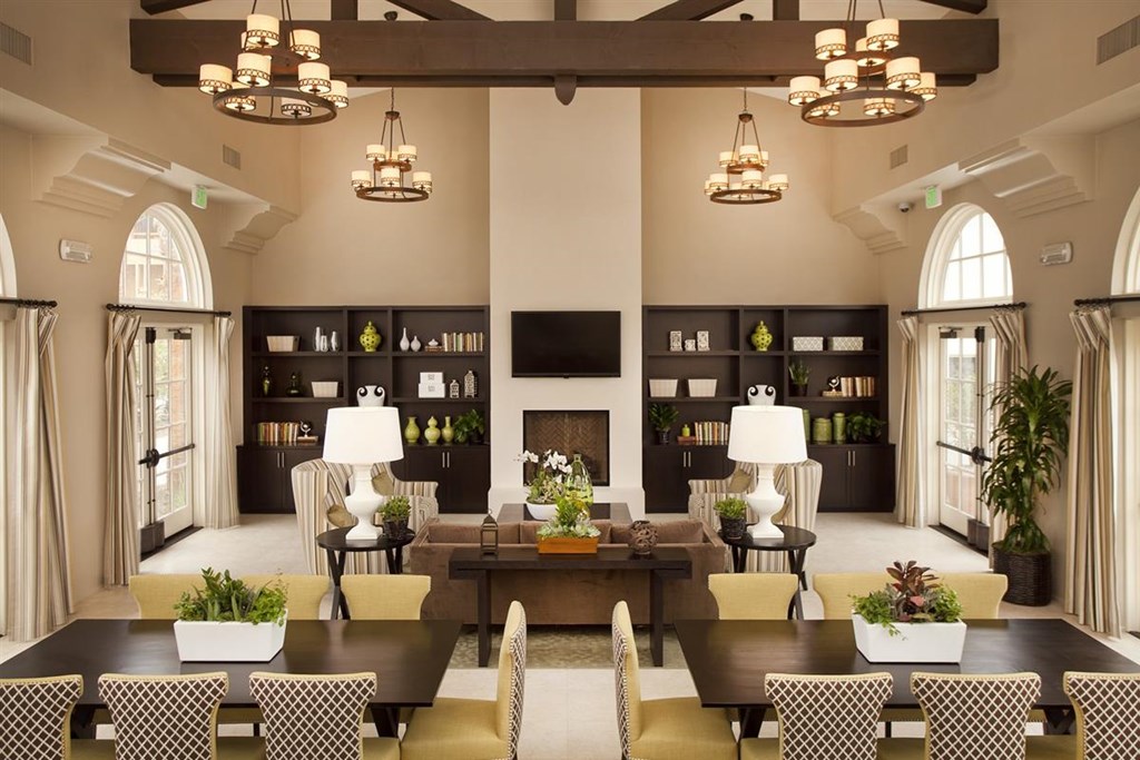 a large living room with a table and chairs