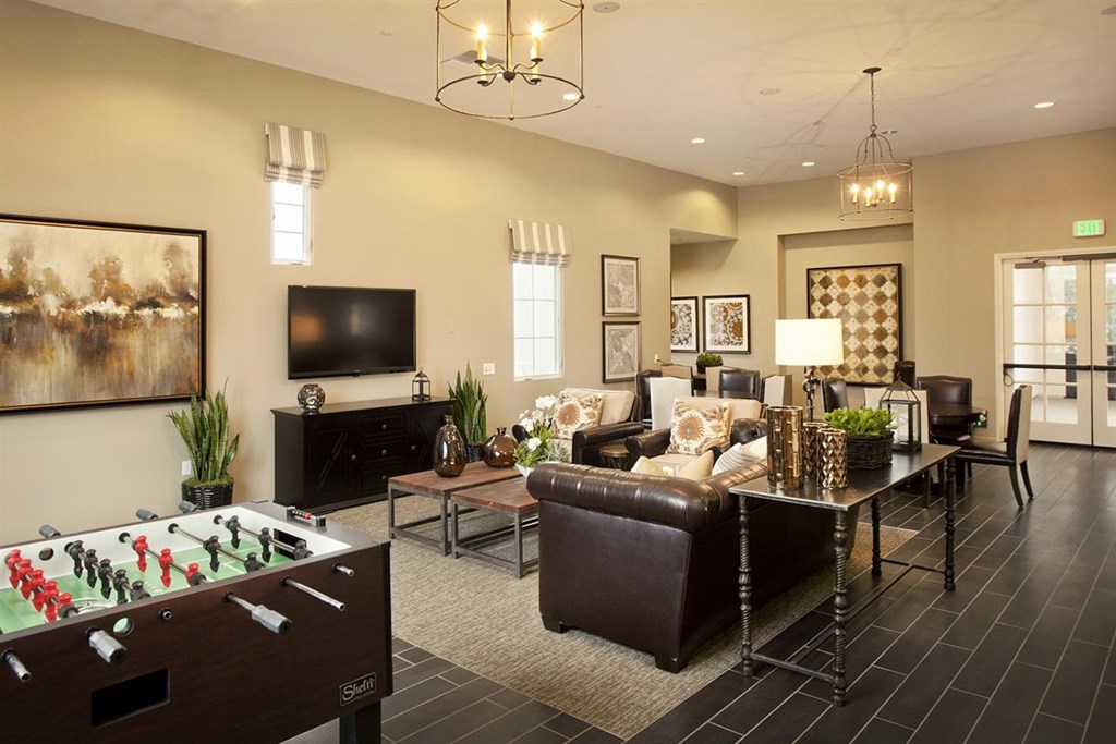 a living room with a pool table and a television