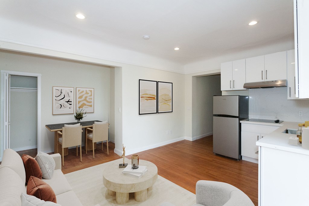 A modern living room with a dining table and chairs.