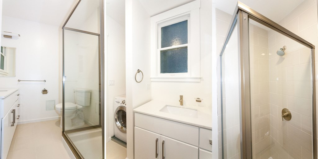 A white bathroom with a glass shower door and a white sink.