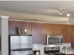 Eat-in Kitchen with Stainless Appliances, Quartz Counter Tops and Custom Cabinetry Stainless Silver Appliances at The Can Plant Residences at Pearl, San Antonio, TX,78215