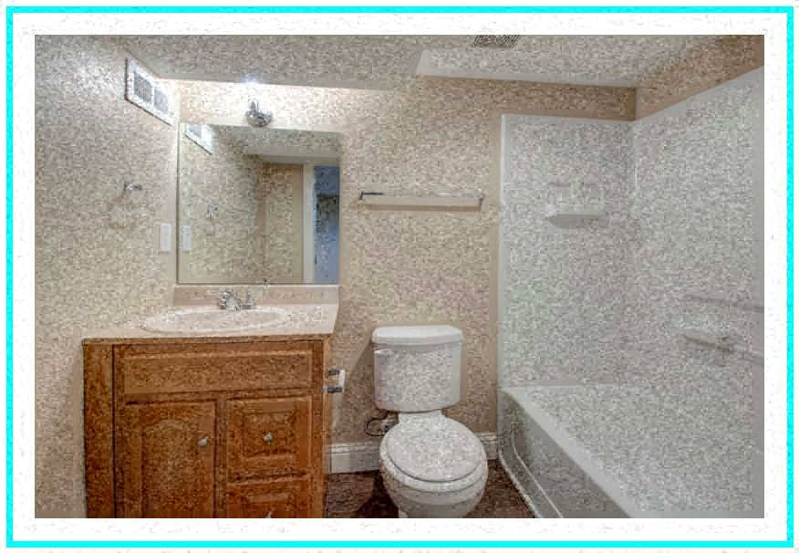 a bathroom with a toilet and a sink and a tub