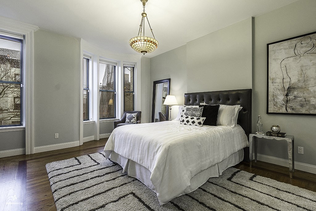 a bedroom with a bed and a rug