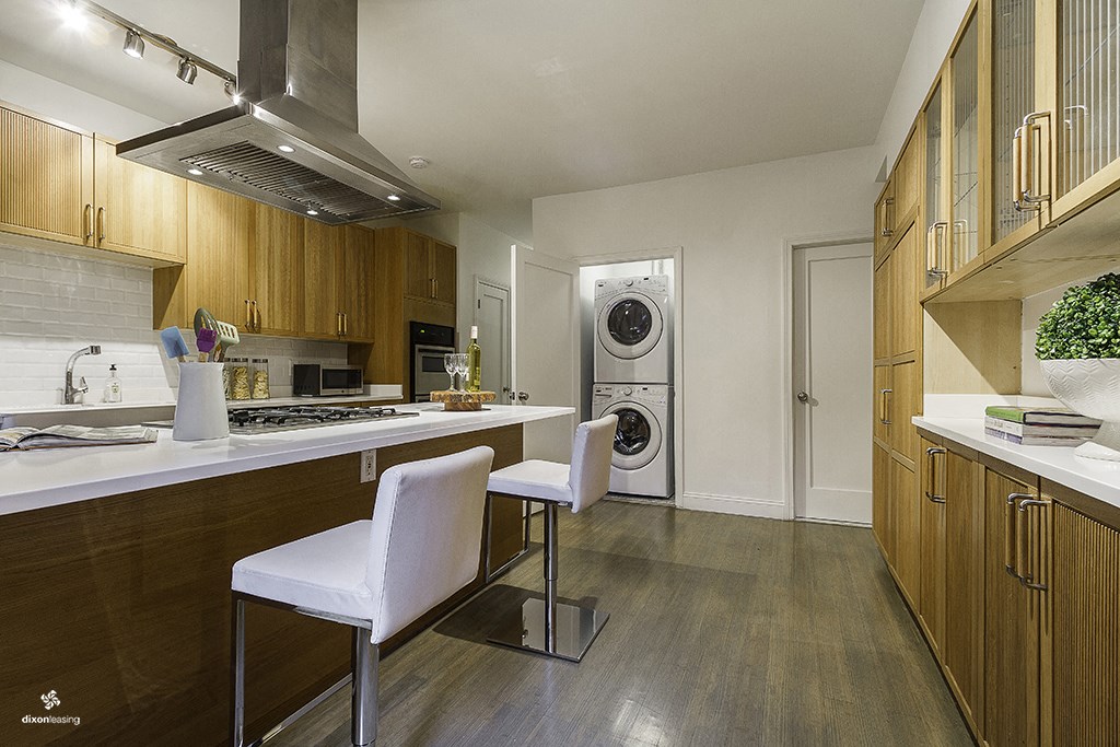 a kitchen with a table and chairs and a washing machine