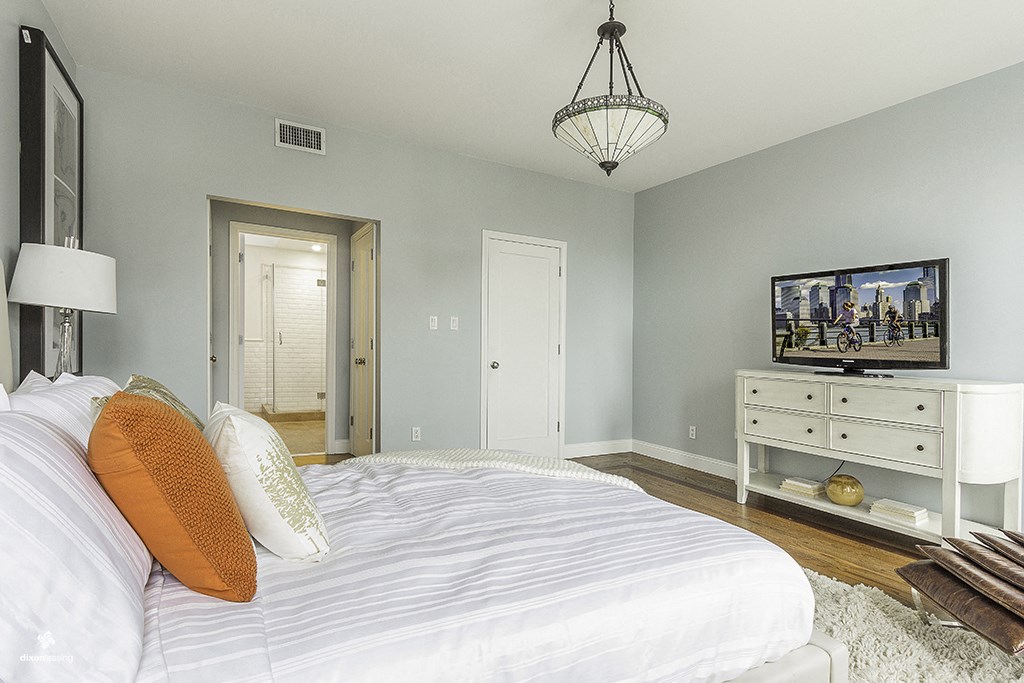 a bedroom with a large bed and a tv