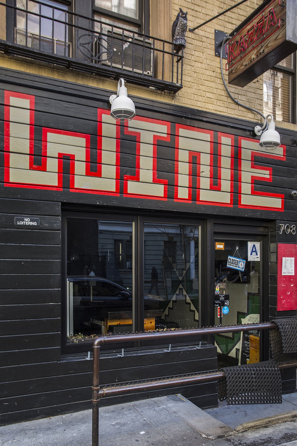 a neon sign for a movie theater on the side of a building