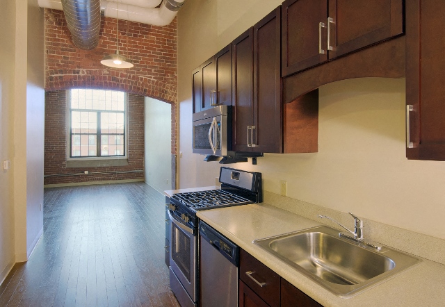 a kitchen with a sink and a stove and a window