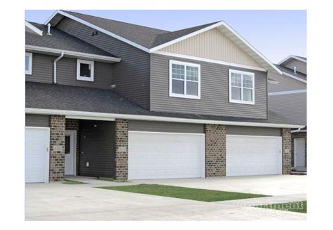a house with two garage doors in front of it
