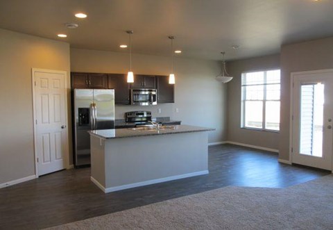 an empty kitchen with an island in the middle