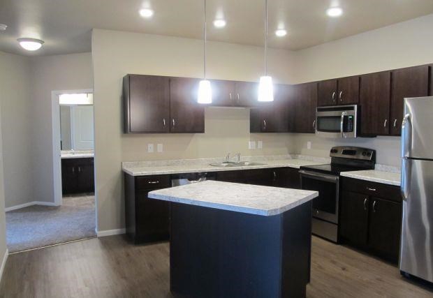 a kitchen with an island in the middle of it