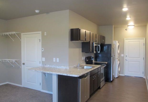 a kitchen with a counter top and a refrigerator