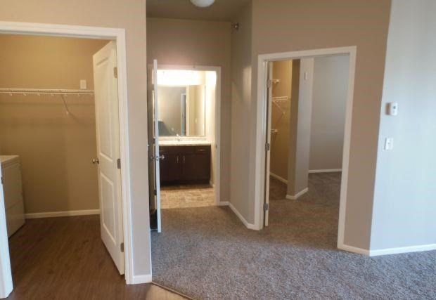 an empty room with a bathroom and a closet