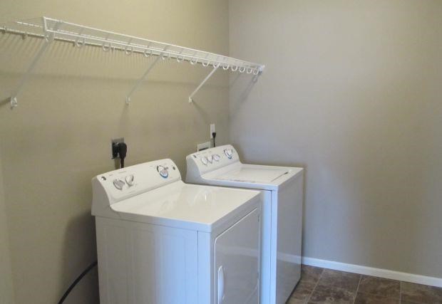 a laundry room with two washes and a dryer