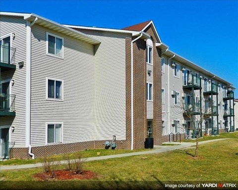a large apartment building with a sidewalk