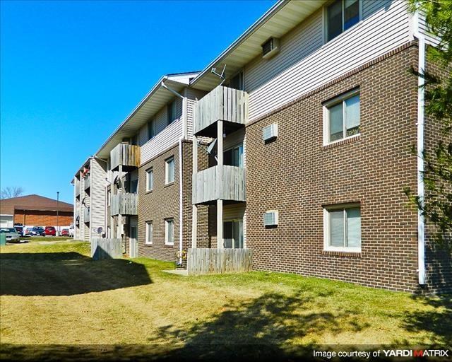 a brick apartment building with balconies on the side