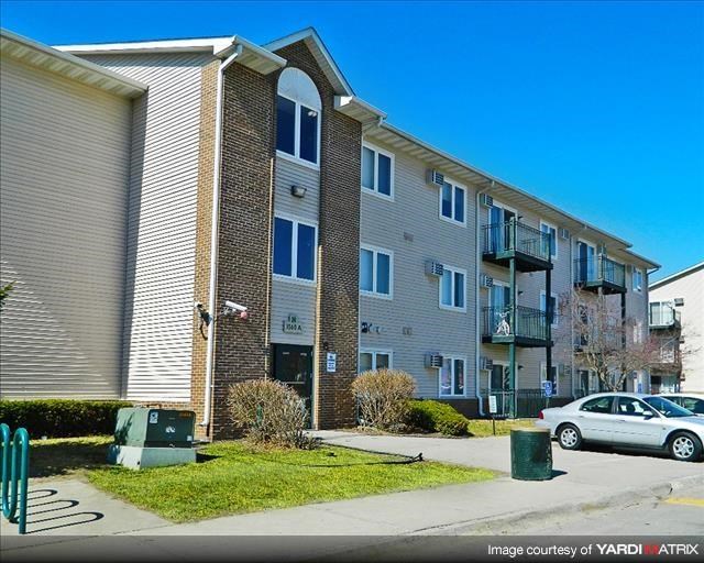 an apartment building with a car parked in front of it