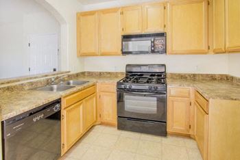kitchen with dishwasher and oven at The Village Apartments, California, 91406