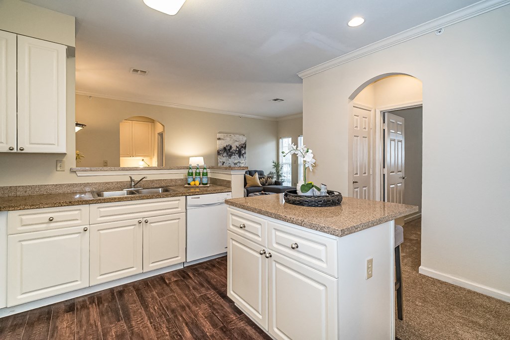a kitchen with white cabinets and a counter top