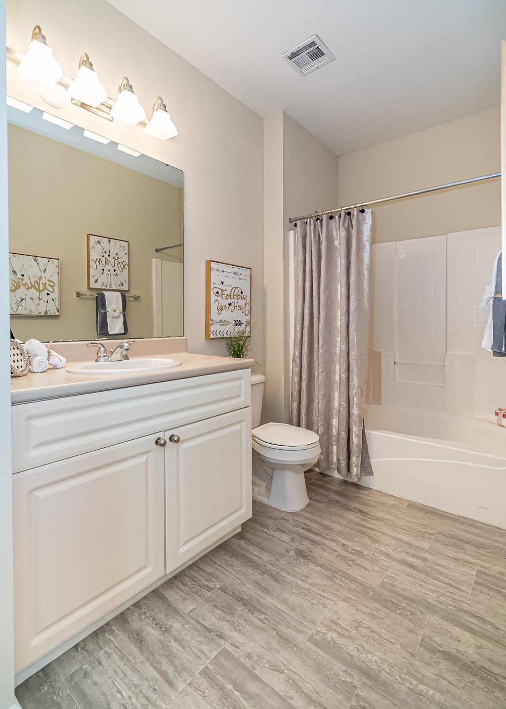 a bathroom with a toilet and a shower and a sink