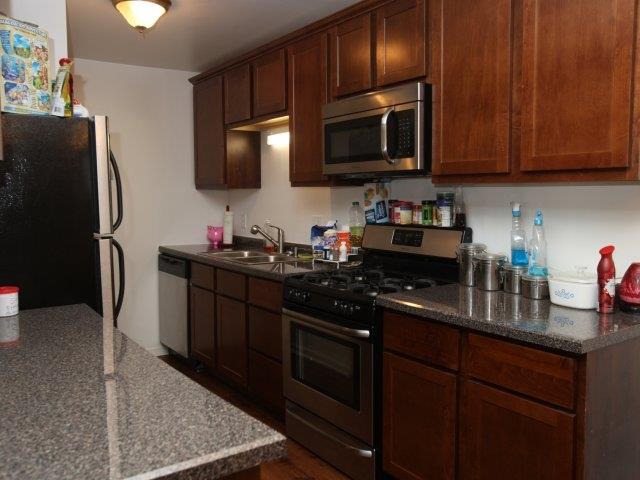 a kitchen with stainless steel appliances and granite counter tops