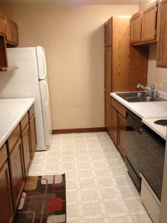 a kitchen with a sink and a refrigerator