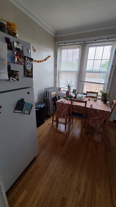 a kitchen with a table and a refrigerator