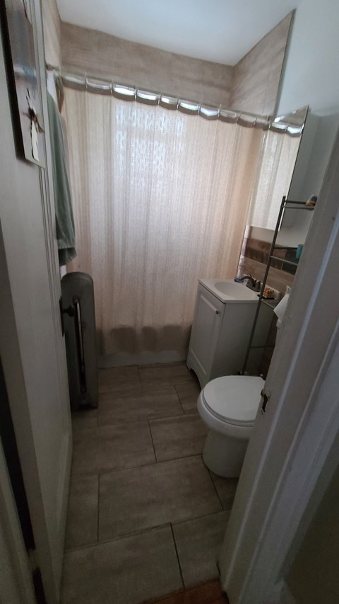 a small bathroom with a toilet and a shower