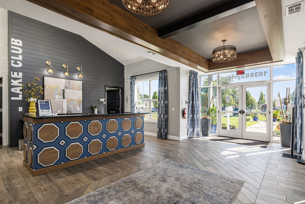 a lobby with a reception desk and glass doors
