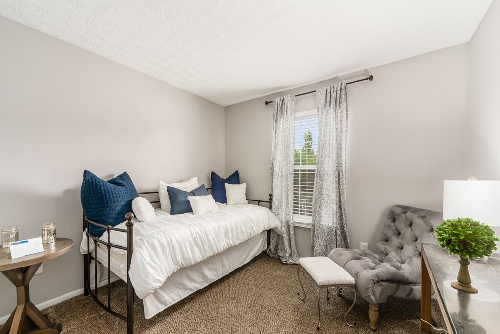 a bathroom with a toilet sink and tub and a mirror