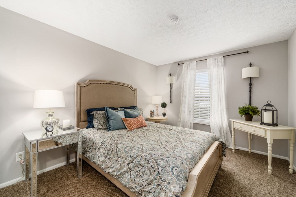 a bedroom with a large bed and a window