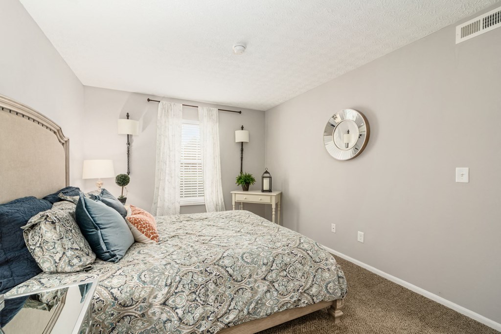 a bedroom with a large bed and a window
