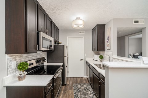 a kitchen and dining room with a table and chairs
