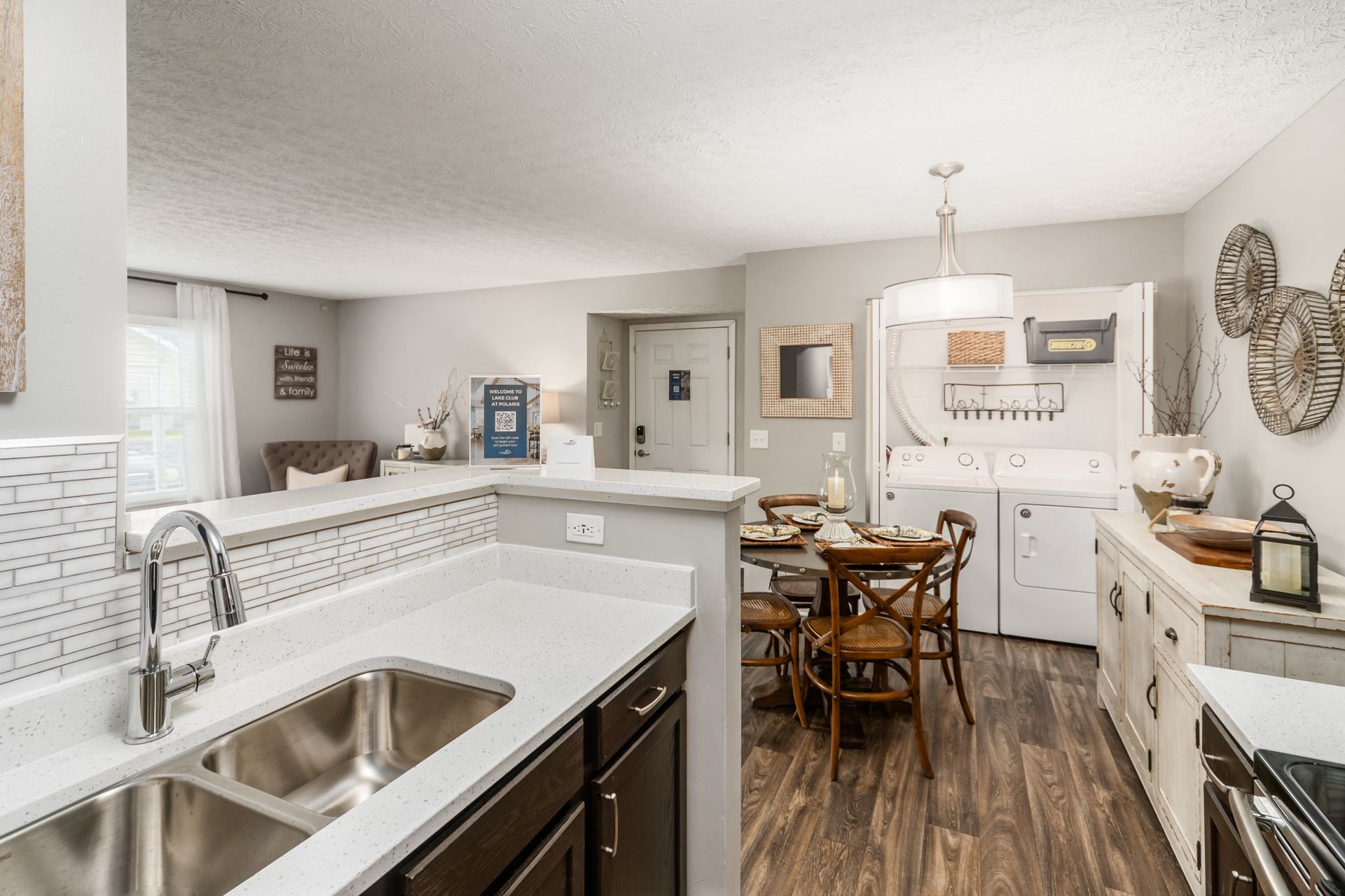 the kitchen and dining area of a house with white appliances and a sink