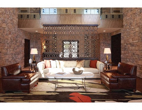 a living room with a white couch and leather furniture