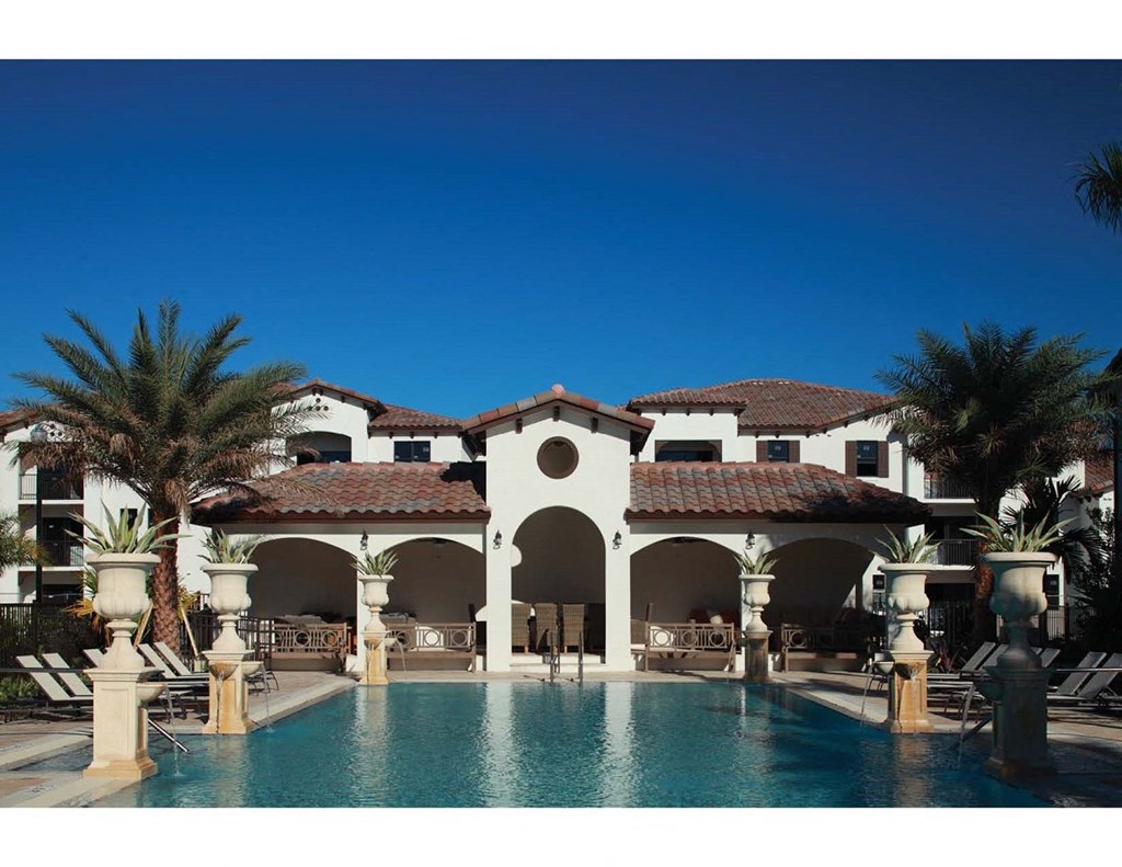 a mansion with a large pool and palm trees