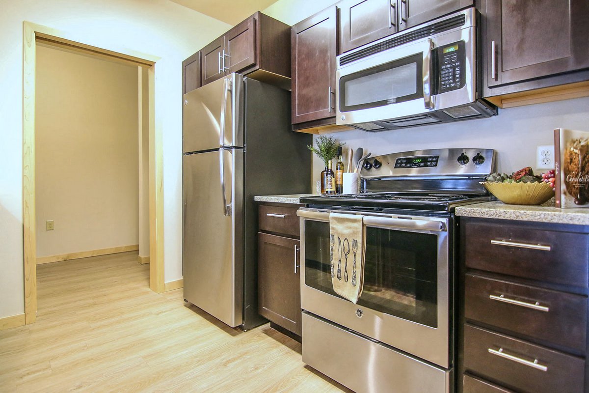 a kitchen with stainless steel appliances and a refrigerator