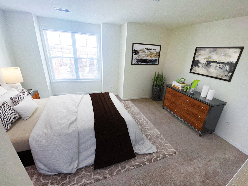 a bedroom with a bed and a dresser in it