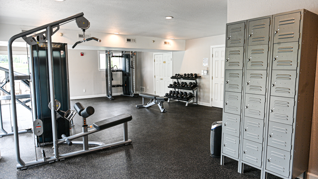 a gym with weights and other equipment and lockers