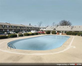 a large swimming pool in front of a building