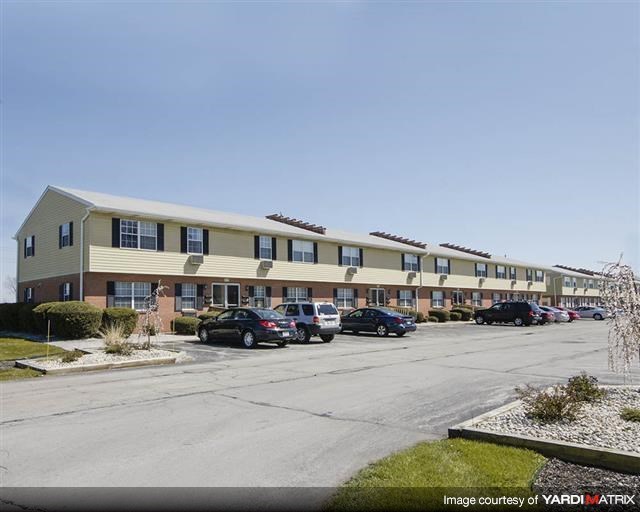a large building with cars parked in a parking lot