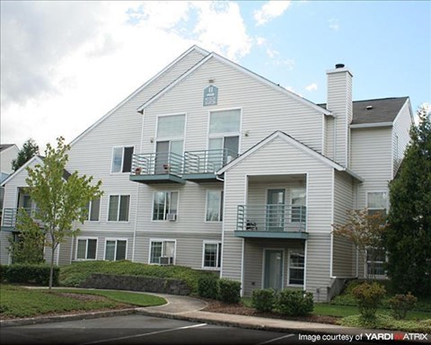 A two-story house with a balcony on the second floor.