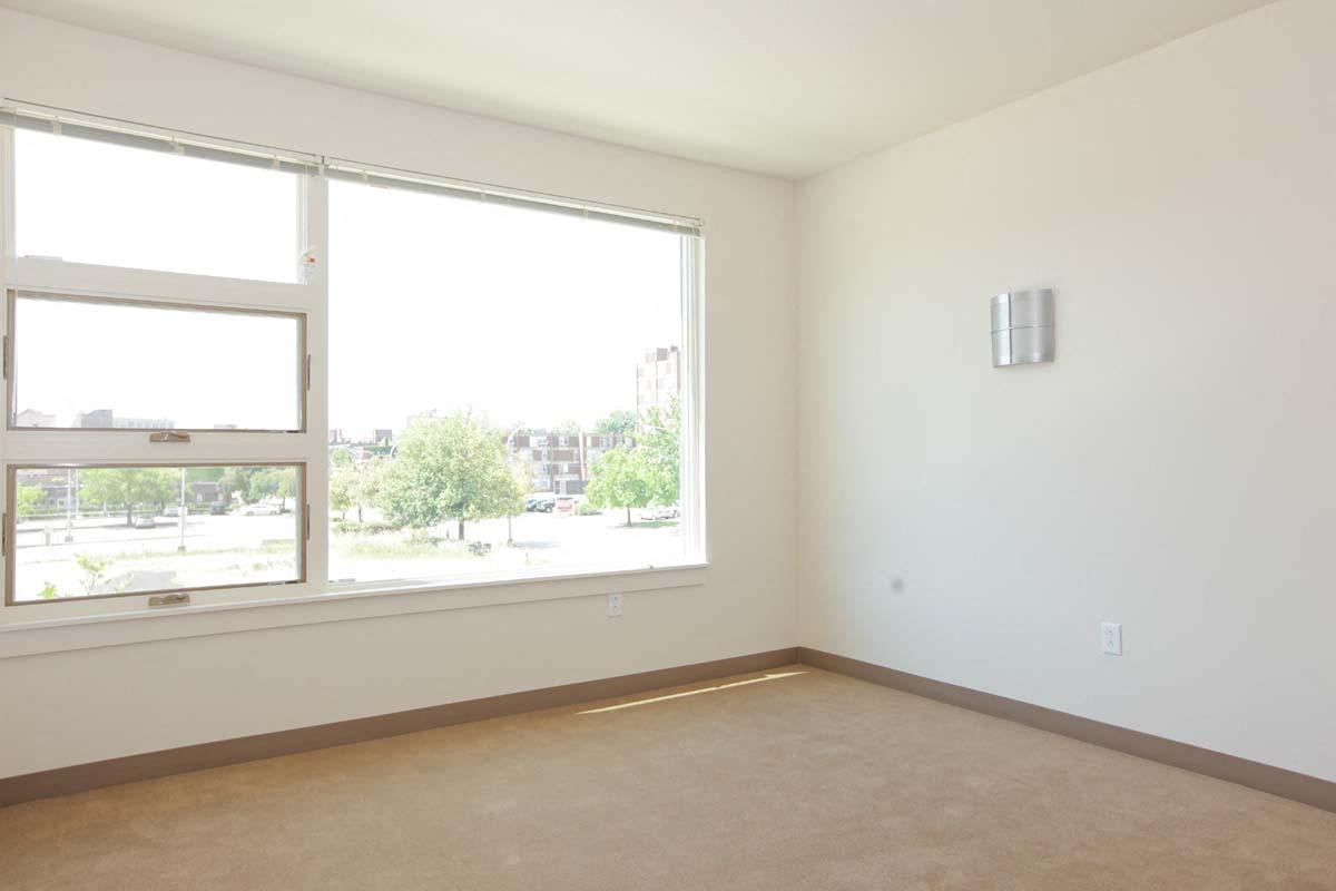 an empty living room with a large window