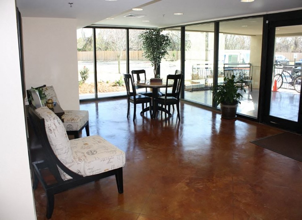 a living room with a table and chairs and sliding glass doors