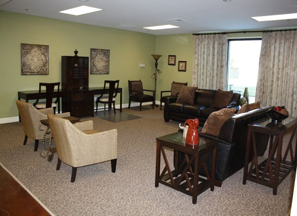 a living room with a couch and chairs and a table