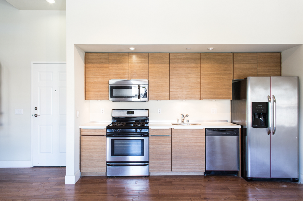 a kitchen with stainless steel appliances and wooden cabinets