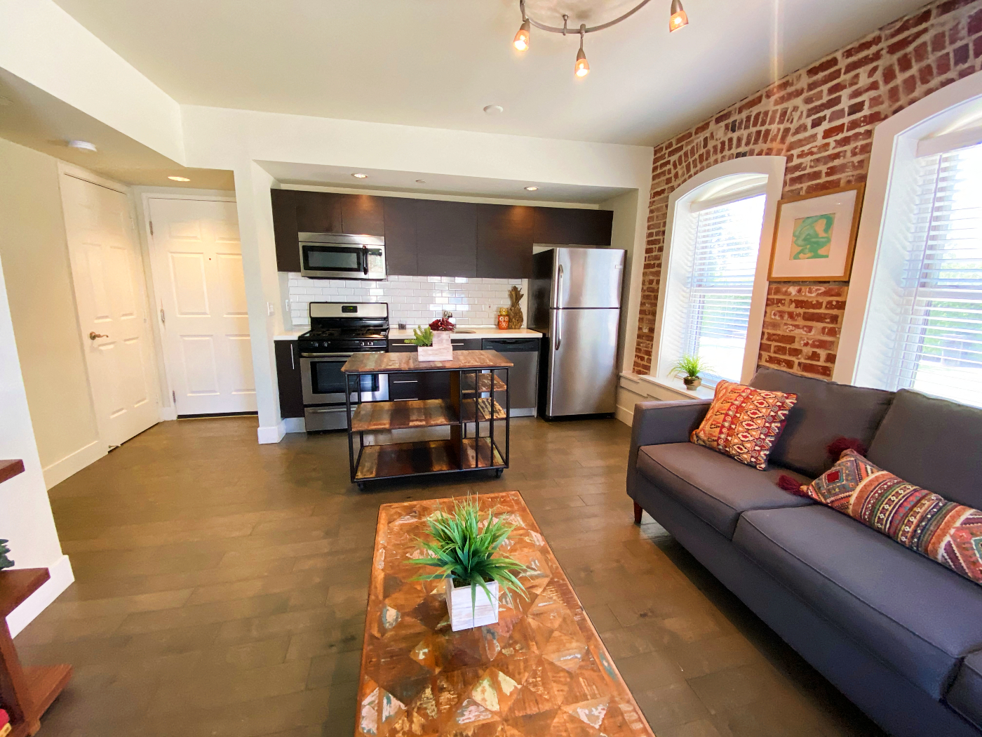 a living room and kitchen with a couch and a coffee table