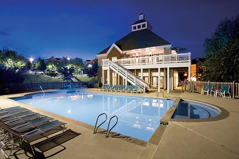 a large swimming pool in front of a house